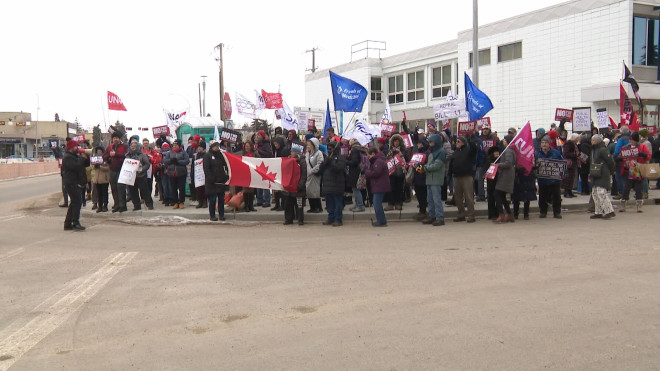 A large crowd gathered outside the office of Edmonton Liberal MP Eleanor Olszewski on Monday, one of more than a dozen rallies held across Canada, calling on Ottawa to protect the country's public health care system.